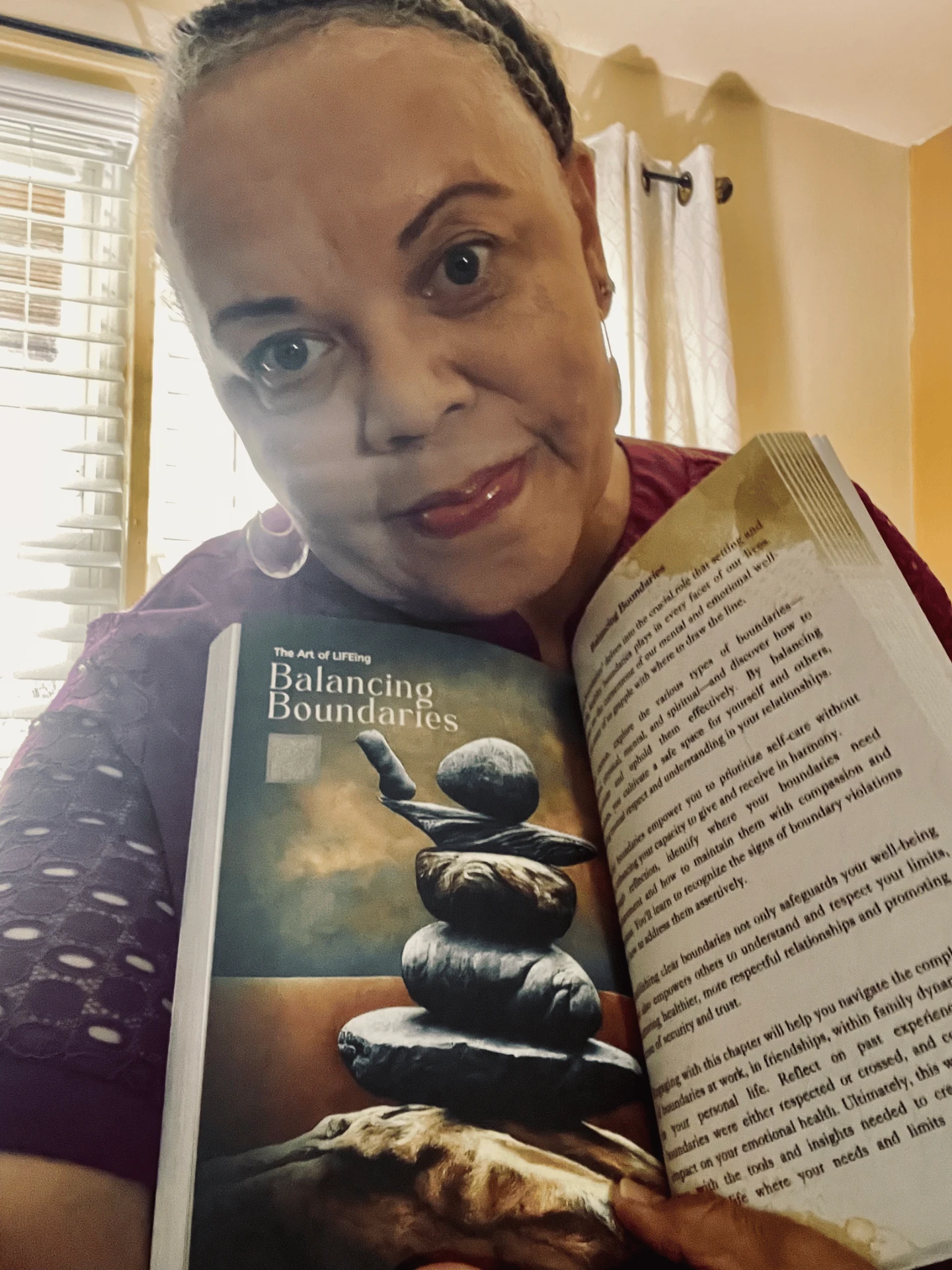 Reader holding The Art of LIFEing Journal open to the Balancing Boundaries chapter