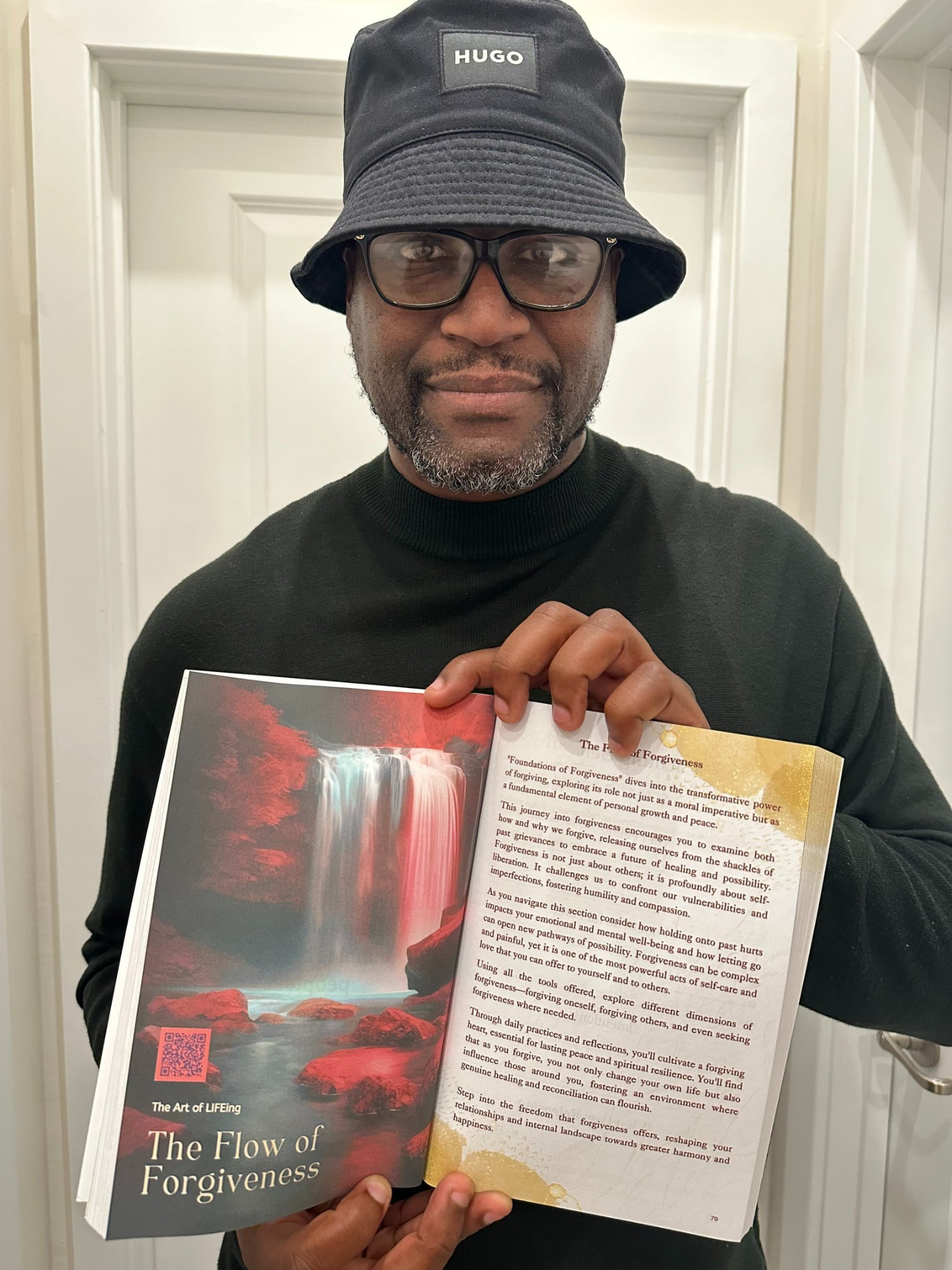Reader holding The Art of LIFEing Journal open to The Flow of Forgiveness chapter