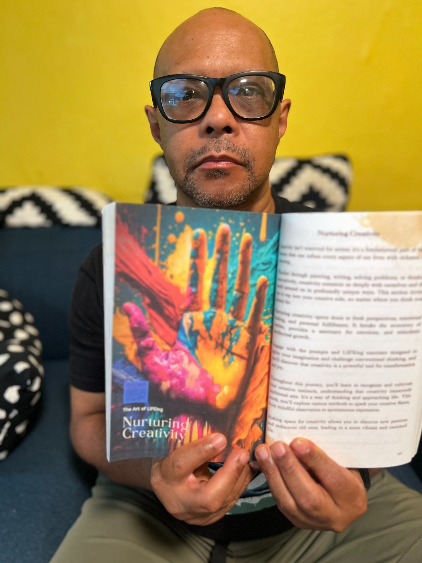 Reader holding The Art of LIFEing Journal open to the Nurturing Creativity chapter